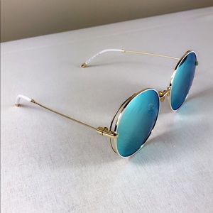Sea blue mirror tinted and gold frame sunglasses.